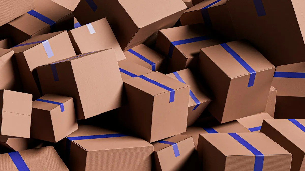 A pile of brown cardboard boxes sealed with blue tape A pile of brown cardboard boxes sealed with blue tape