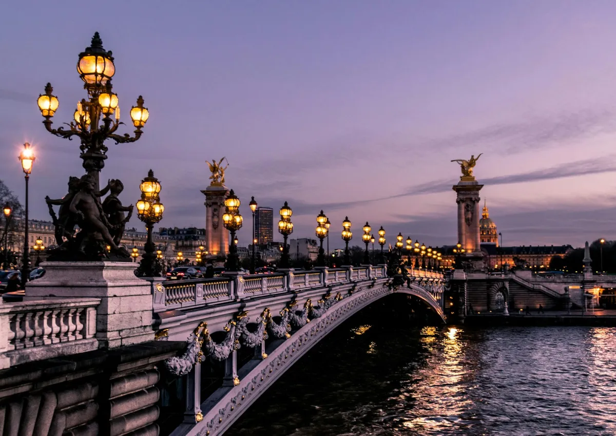 Pont Alexandre III lit up at dusk over the Seine in Paris
