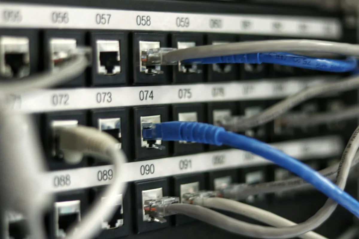 Blue and grey network cables plugged into a numbered patch panel Blue and grey network cables plugged into a numbered patch panel