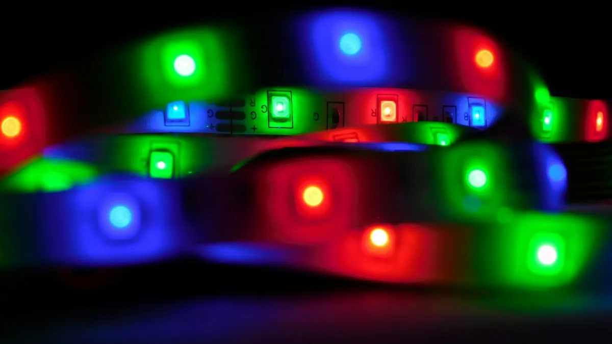 A coiled RGB LED strip glowing red, green and blue in the dark