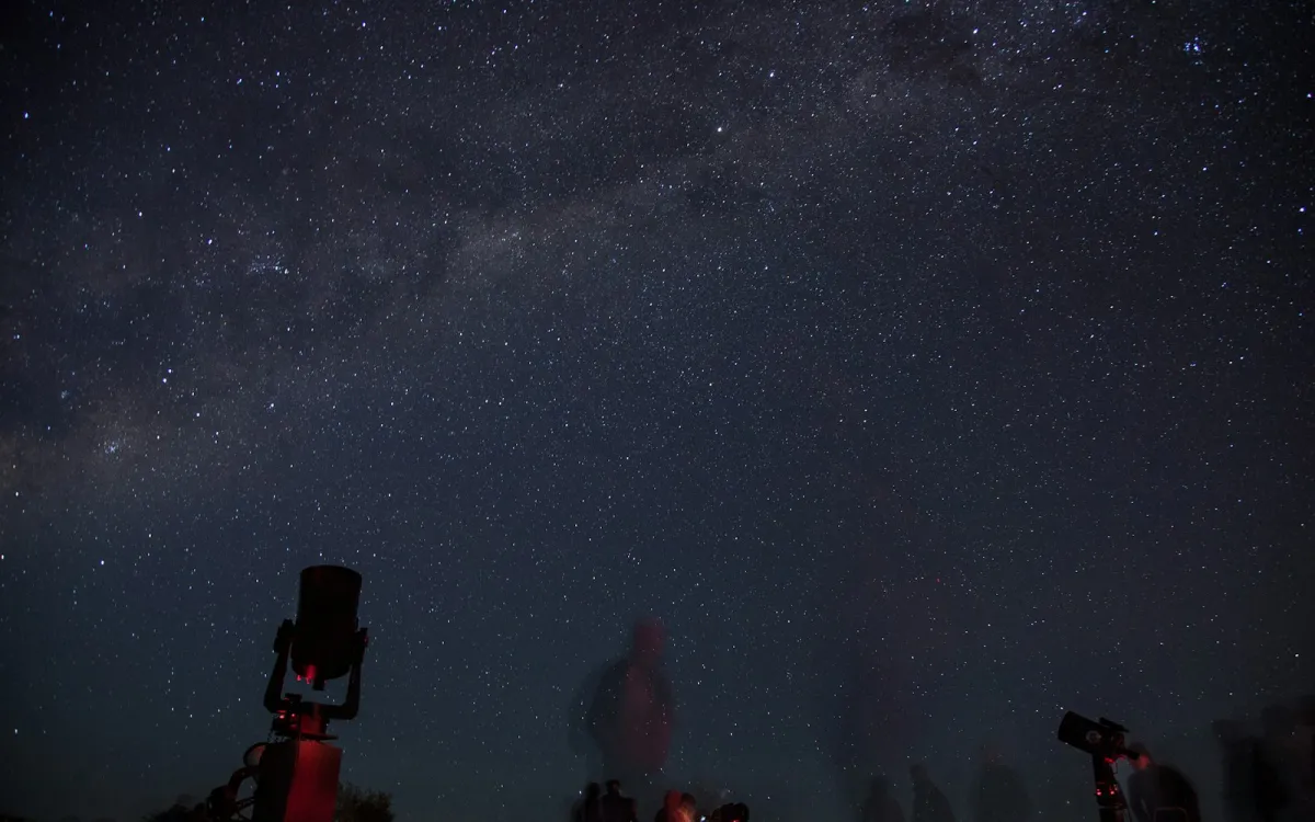 Telescopes silhouetted under a starry night sky and the Milky Way Telescopes silhouetted under a starry night sky and the Milky Way
