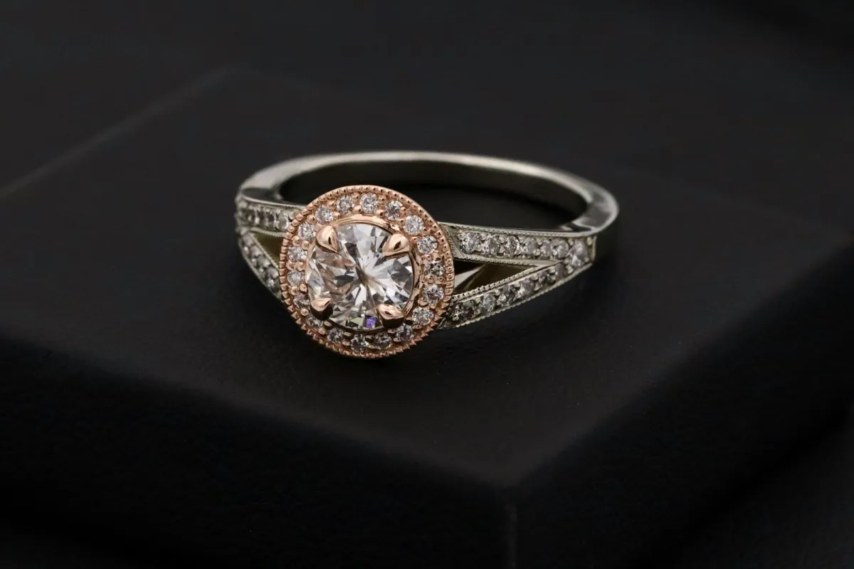 A diamond halo engagement ring on a black display box