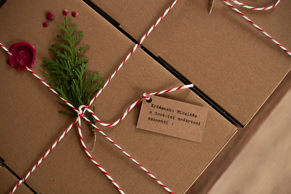 Brown gift boxes tied with red and white twine and a handwritten gift tag Brown gift boxes tied with red and white twine and a handwritten gift tag