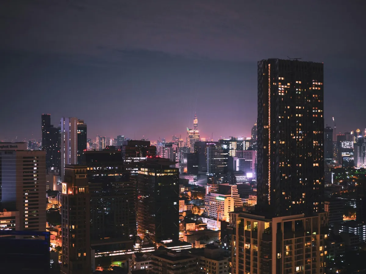 Bangkok's city skyline lit up at night, seen from a rooftop Bangkok's city skyline lit up at night, seen from a rooftop