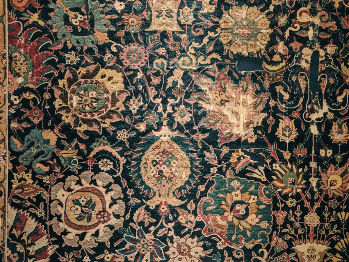 Close-up of a richly patterned traditional rug in dark blue, red and gold Close-up of a richly patterned traditional rug in dark blue, red and gold
