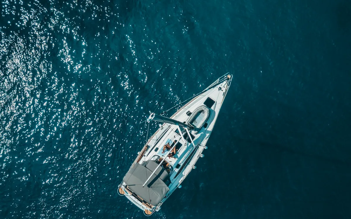 Aerial view of a white sailing yacht on deep blue Mediterranean water off Hvar Aerial view of a white sailing yacht on deep blue Mediterranean water off Hvar