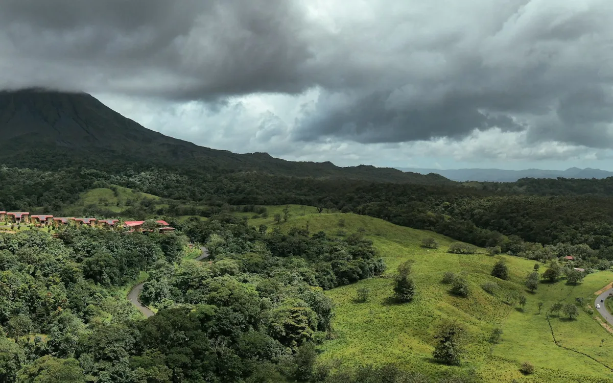 Cloud over forested green hills and mountains in Costa Rica