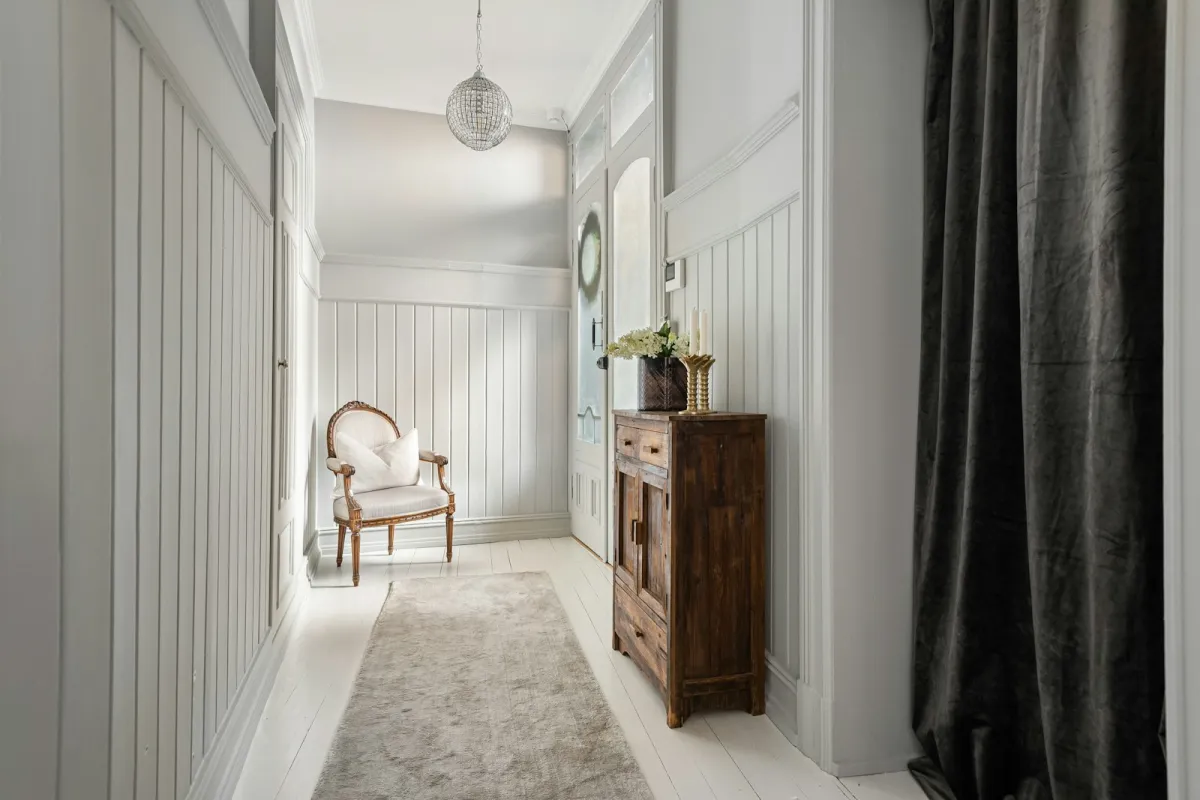 A pale grey hallway with tongue-and-groove wall panelling, dado rail and skirting A pale grey hallway with tongue-and-groove wall panelling, dado rail and skirting