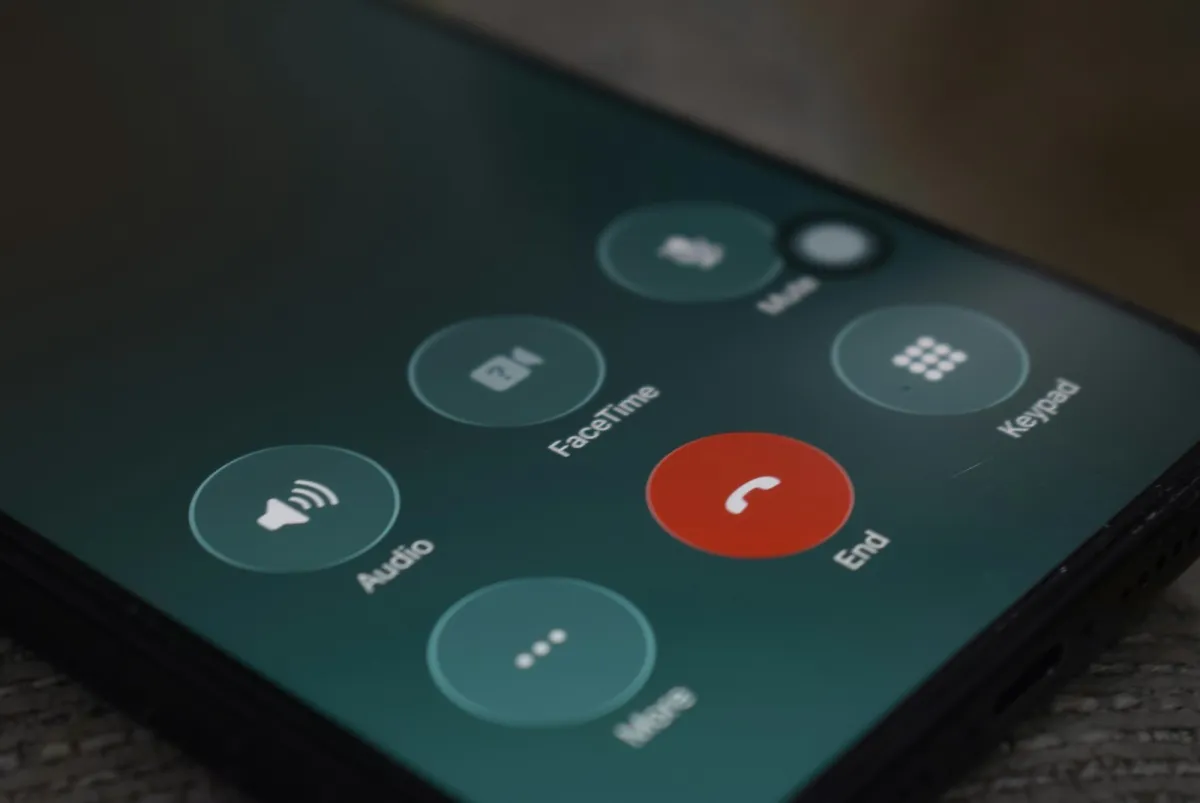 Close-up of a smartphone screen during a call, with the red end-call button Close-up of a smartphone screen during a call, with the red end-call button