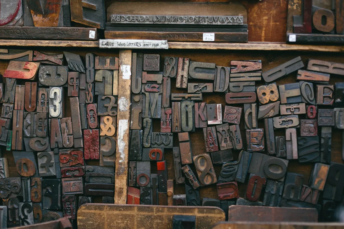 Rows of vintage wooden letter stamps on a market stall Rows of vintage wooden letter stamps on a market stall