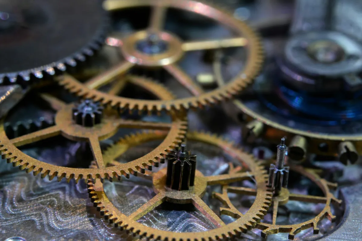 Close-up of brass gear wheels inside a mechanical watch movement Close-up of brass gear wheels inside a mechanical watch movement