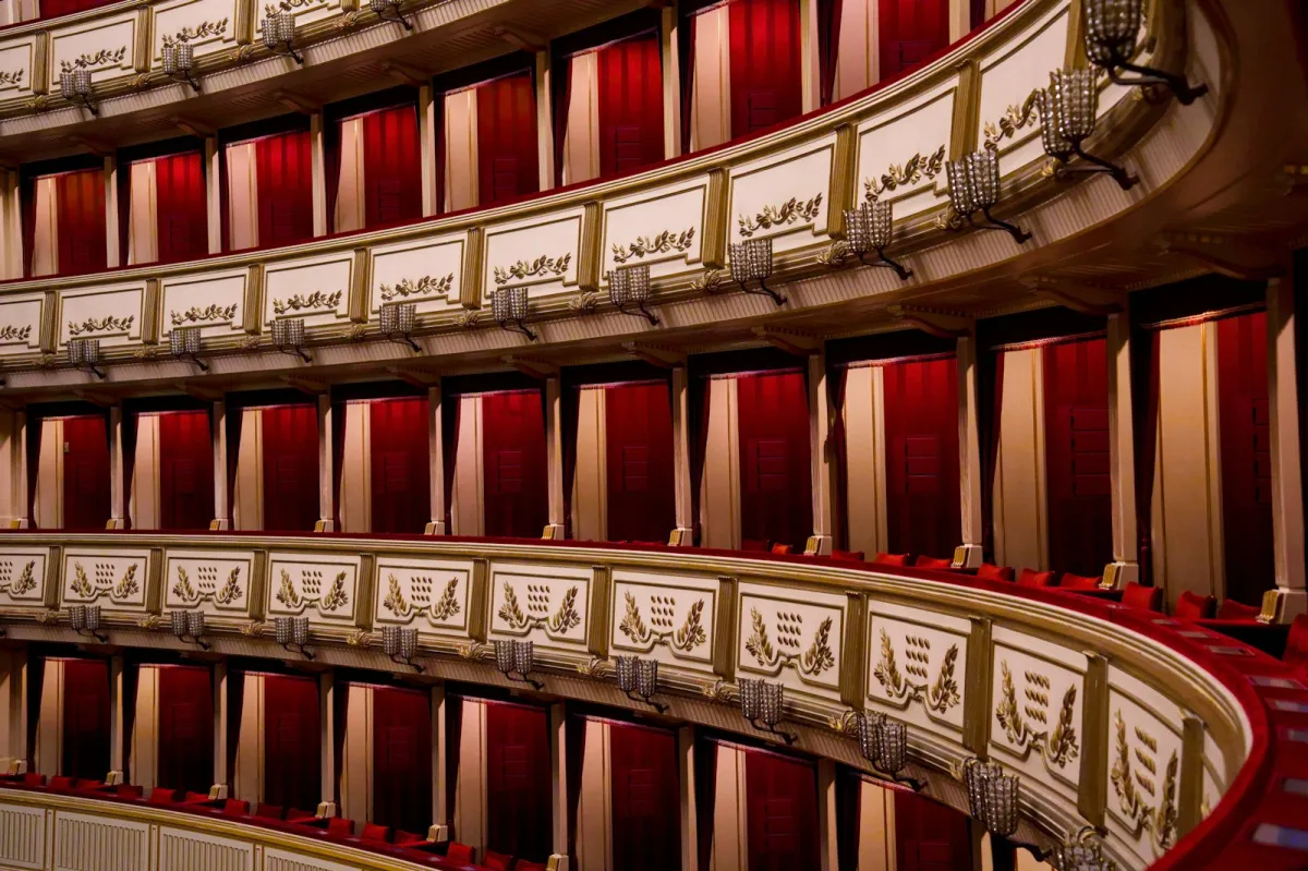 Ornate tiers of theatre boxes with red velvet curtains
