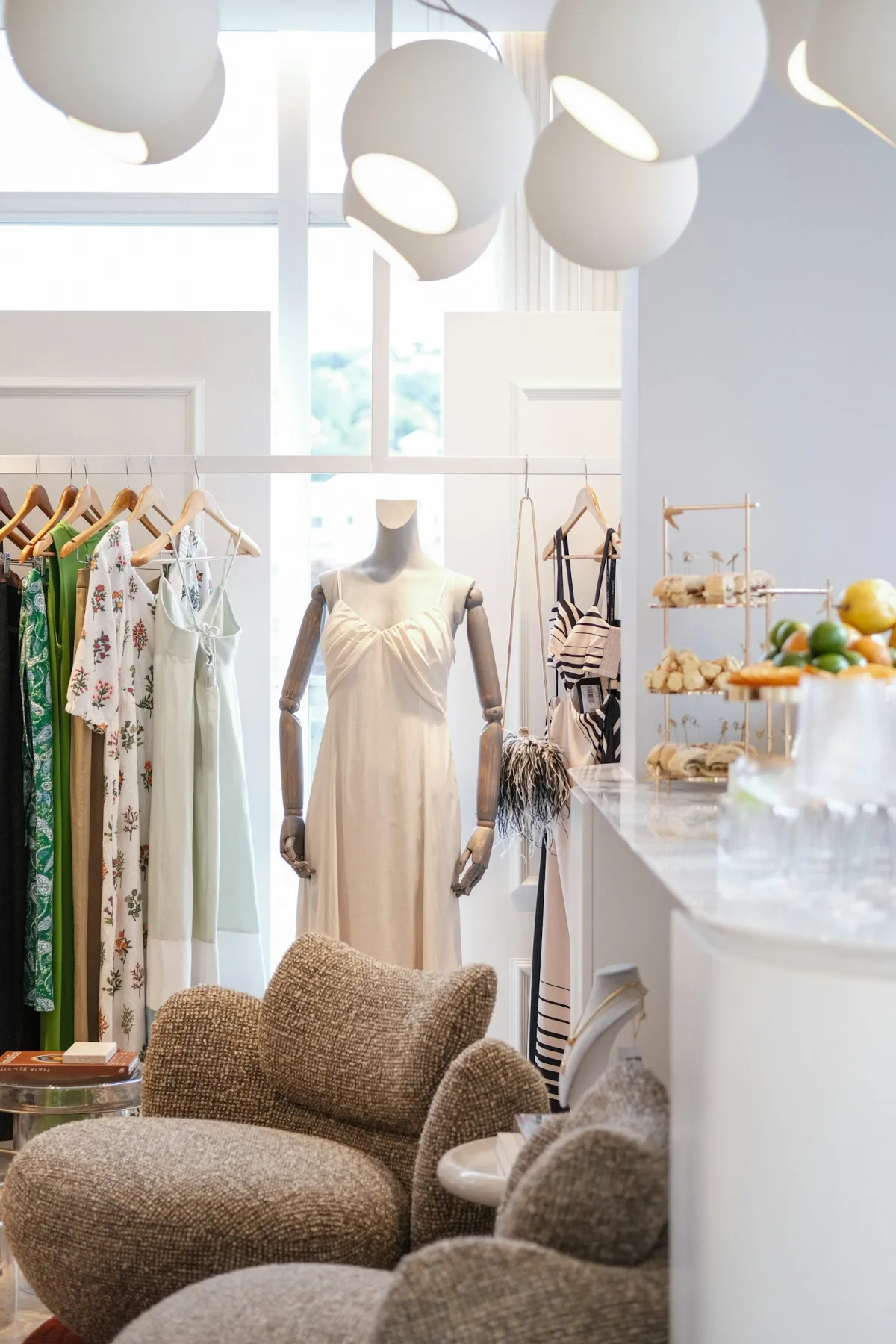 Bright boutique interior with dresses on rails