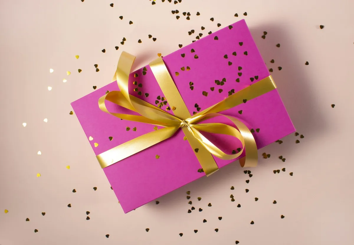 Pink gift box tied with a yellow ribbon