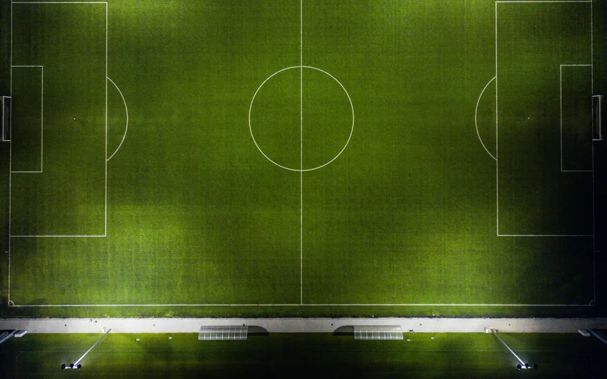 Aerial view of a floodlit football pitch at night Aerial view of a floodlit football pitch at night