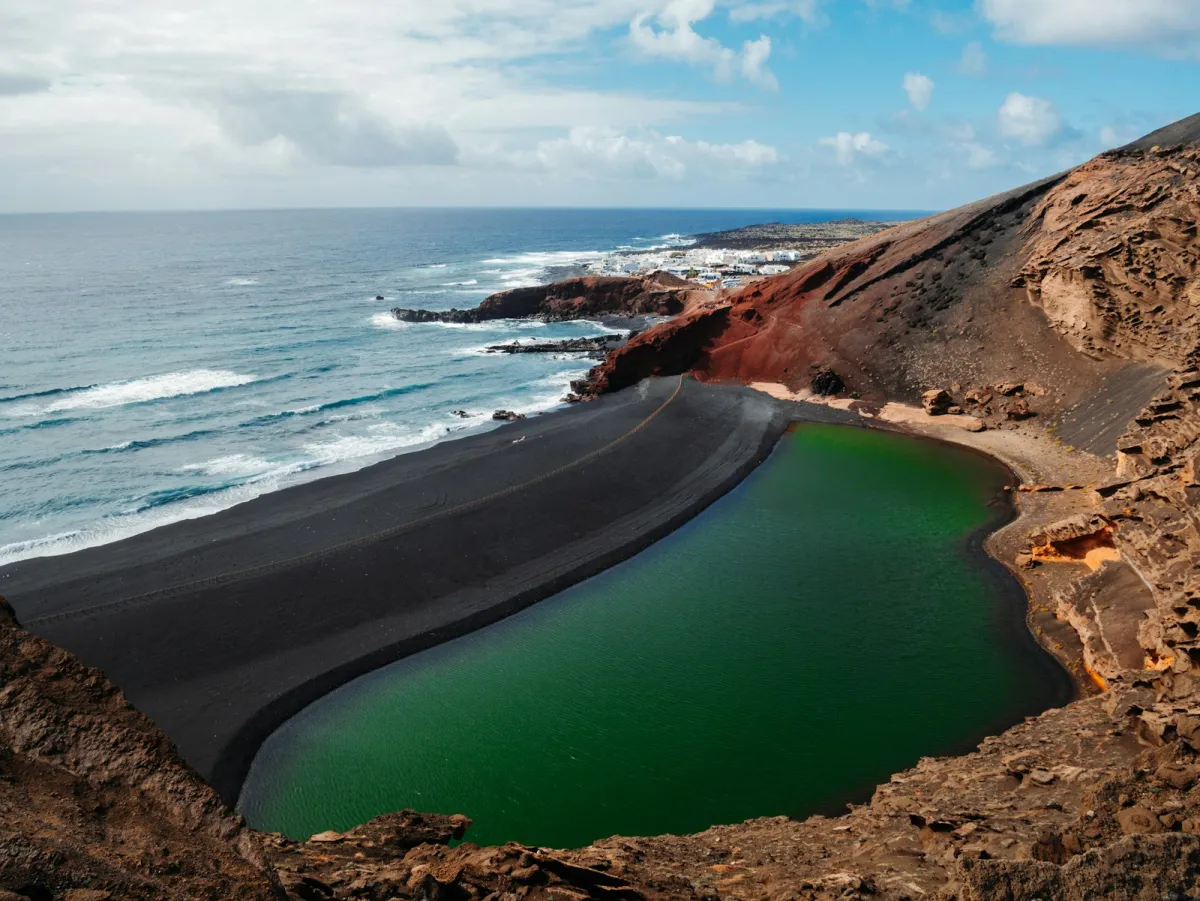 Volcanic mountains meeting the sea on the coast of Lanzarote Volcanic mountains meeting the sea on the coast of Lanzarote