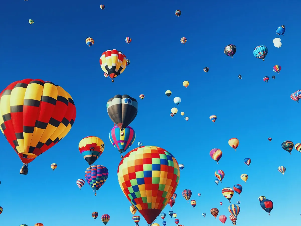 Colourful hot air balloons floating in a clear blue sky