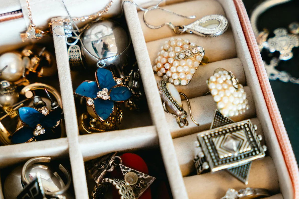 Rings, earrings and necklaces tucked into the compartments of a lined jewellery case Rings, earrings and necklaces tucked into the compartments of a lined jewellery case