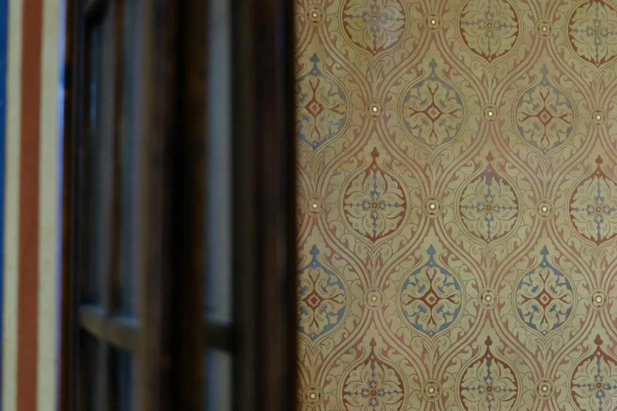 Ornate vintage patterned wallpaper beside a dark wooden window frame Ornate vintage patterned wallpaper beside a dark wooden window frame