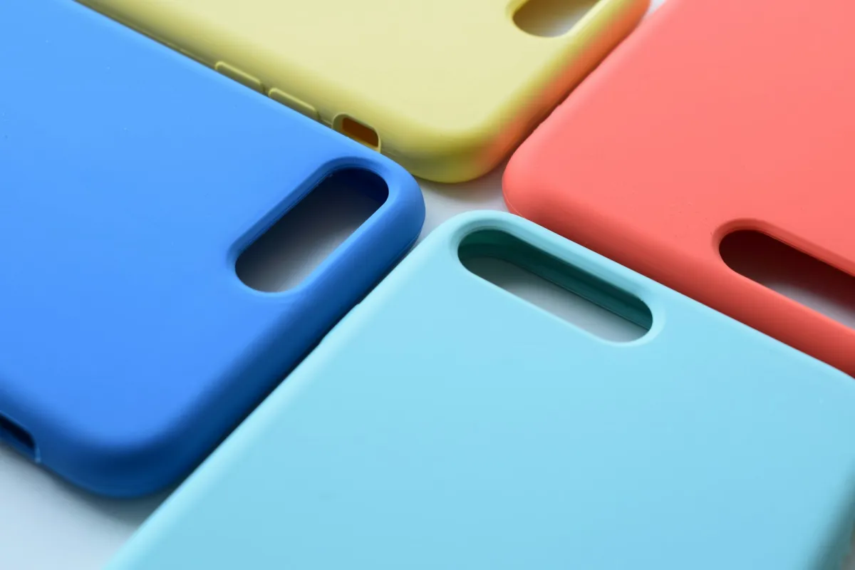 Four plain silicone phone cases in blue, yellow, coral and turquoise