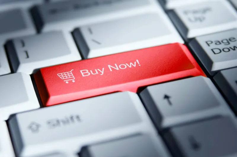 Red Buy Now key with a shopping trolley icon on a computer keyboard