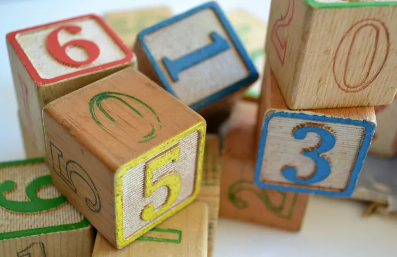 Wooden number blocks piled on a white table