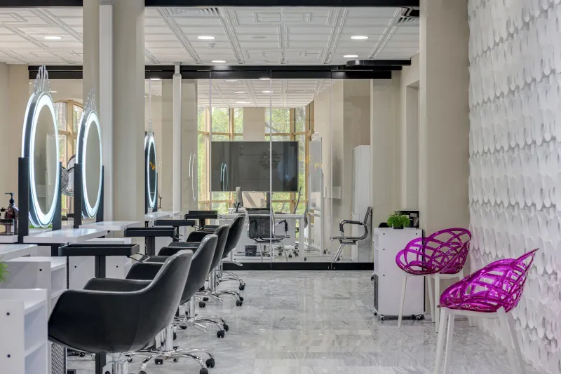 Ashimary Hair: glueless, lace front and bob human hair wigs Empty hair salon with black styling chairs and round lit mirrors