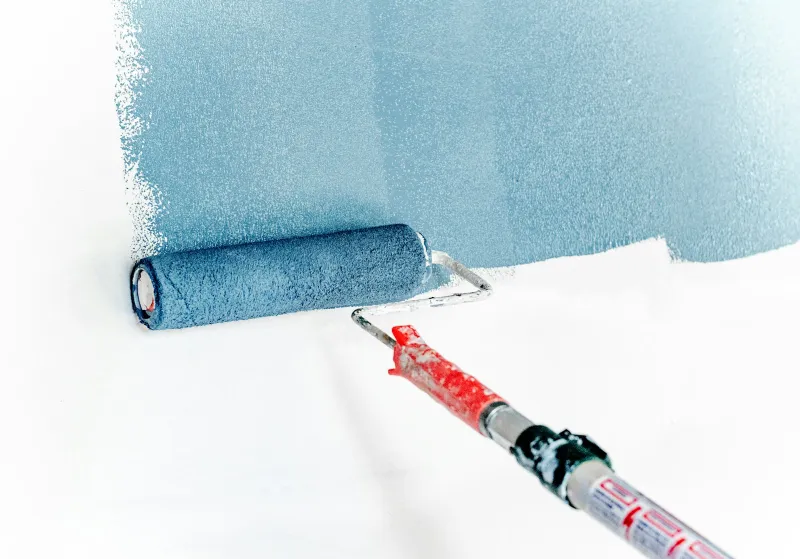 B&Q spotlight: Dulux price cuts, power tool deals and kitchen savings Paint roller applying blue paint to a white wall
