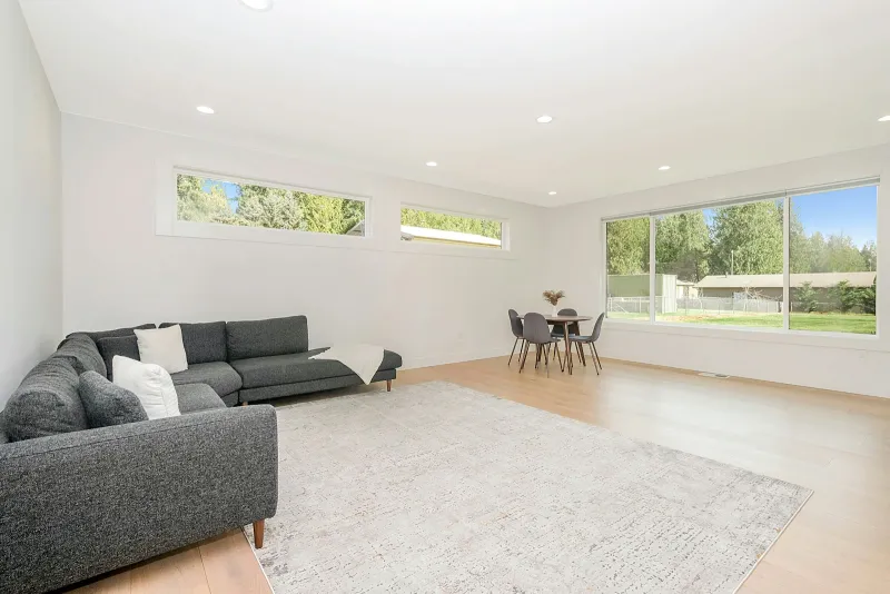 BISSELL: carpet cleaners, spot cleaners and CrossWave from the brand Bright living room with a grey corner sofa, pale rug and wooden floor