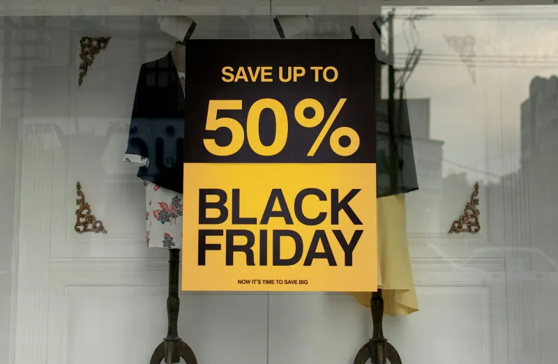 Black Friday sign offering up to 50% off in a shop window