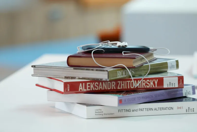 BookBeat: audiobooks and e-books paid for by the hour Stack of books with a phone and white earphones on top