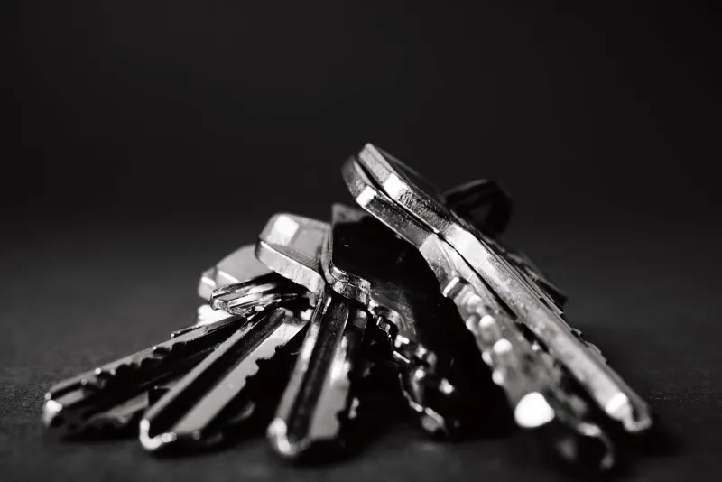 A close-up of a bunch of metal keys on a dark background