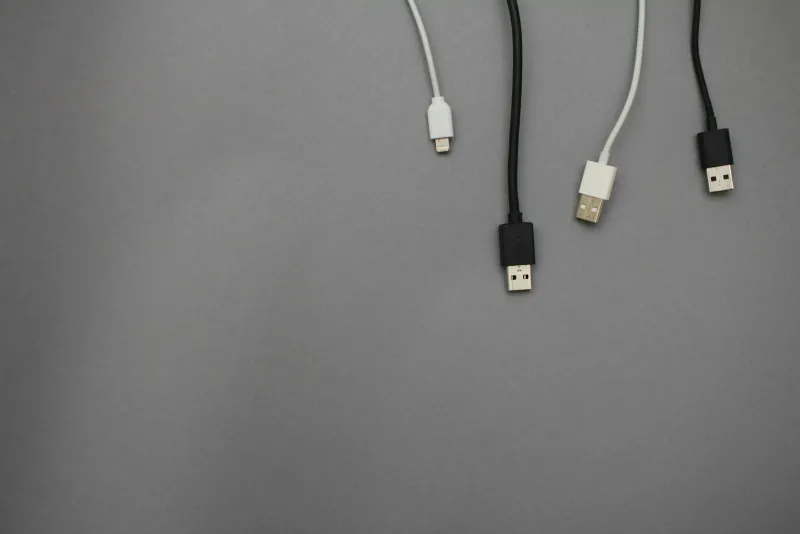 Black and white USB charging cables on a grey background