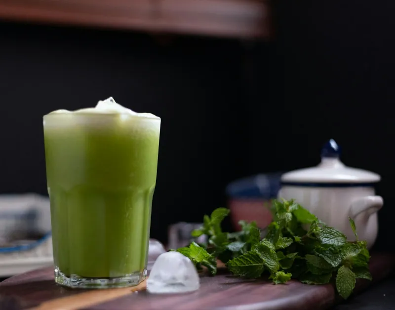 Britt's Superfoods: frozen farm juice shots delivered to your freezer Glass of green juice on a table