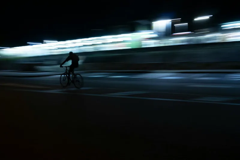 BTR Sports: hi-vis cycling and running kit built for British weather A cyclist riding along a city street at night with blurred lights behind