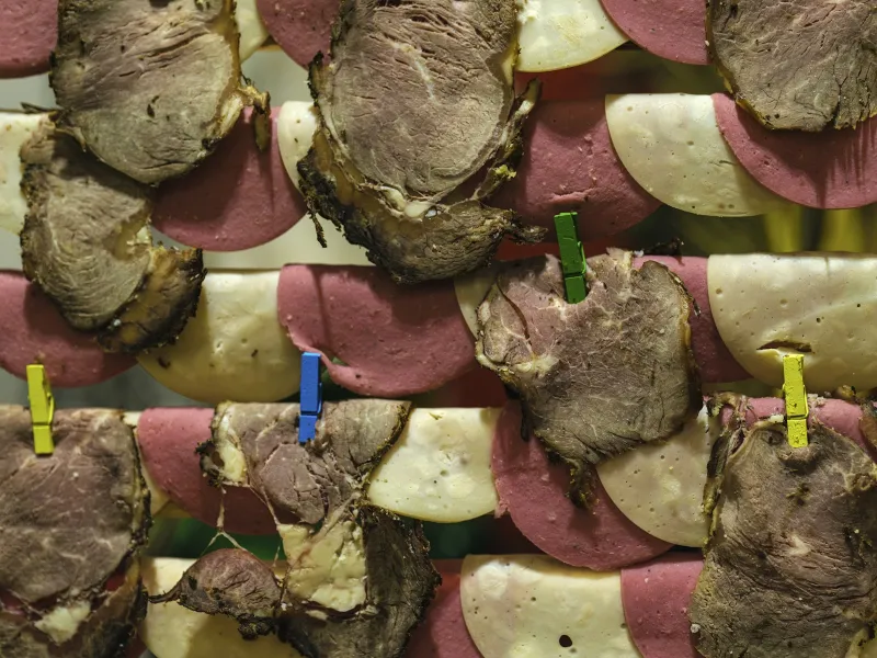 Slices of cured meat and cheese pegged up with colourful clothespins