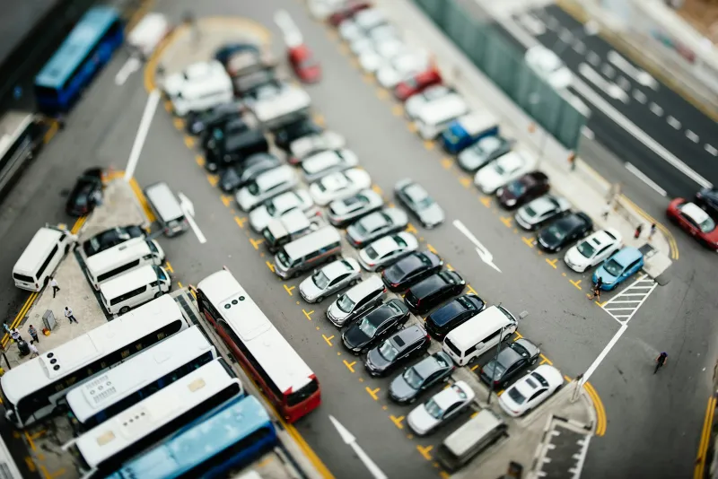 Aerial view of rows of cars, vans and coaches in a car park