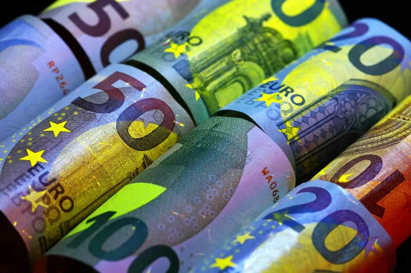 Rolled euro banknotes in different denominations