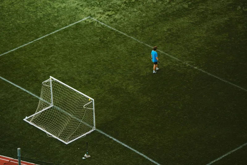 A small football goal on an artificial pitch seen from above