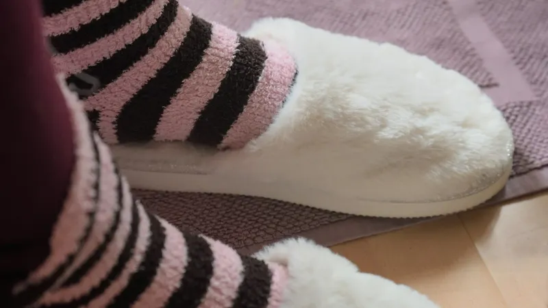 Cosyfeet: extra roomy slippers, shoes and socks from Somerset Feet in striped fluffy socks and white furry slippers on a bath mat