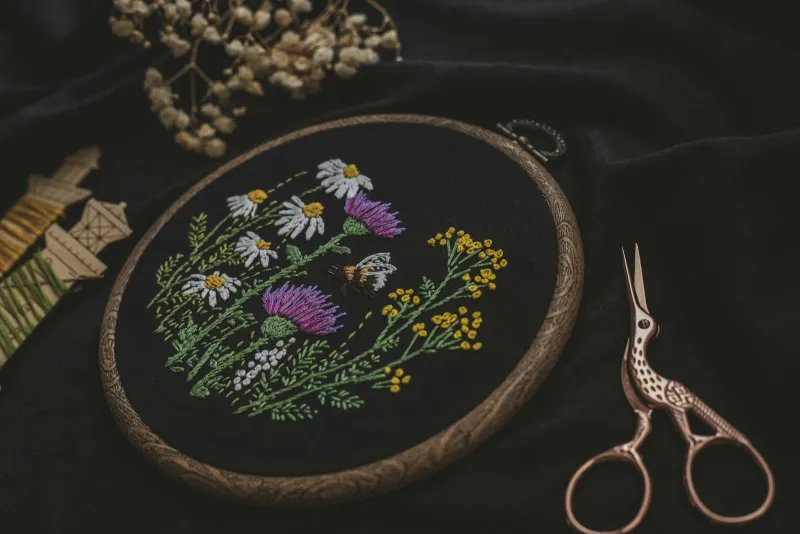 Craftiosity: a new craft project through the post every month Wildflower embroidery in a wooden hoop beside thread and scissors