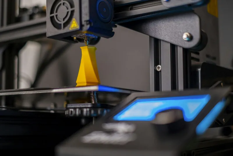 Creality UK: 3D printers, scanners and filament with multi-buy savings A 3D printer nozzle building a yellow plastic model on a lit print bed
