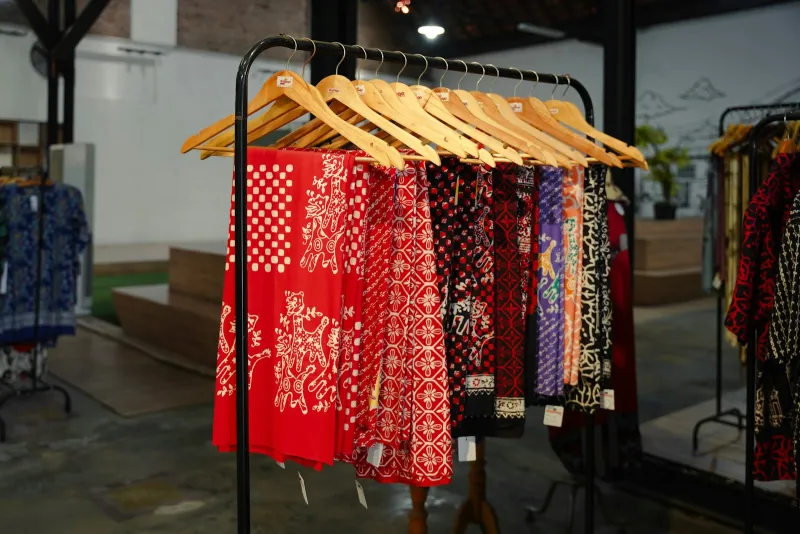 Colourful patterned fabrics hanging on a clothes rail