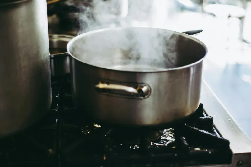 Dexam: family-run kitchenware since 1957 A stainless steel pot steaming on a gas hob