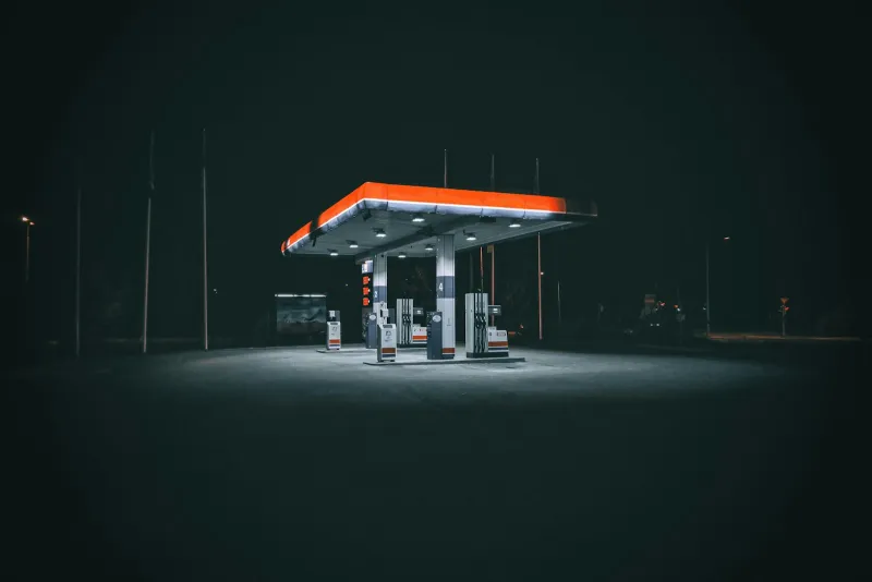 Empty petrol station forecourt lit up at night