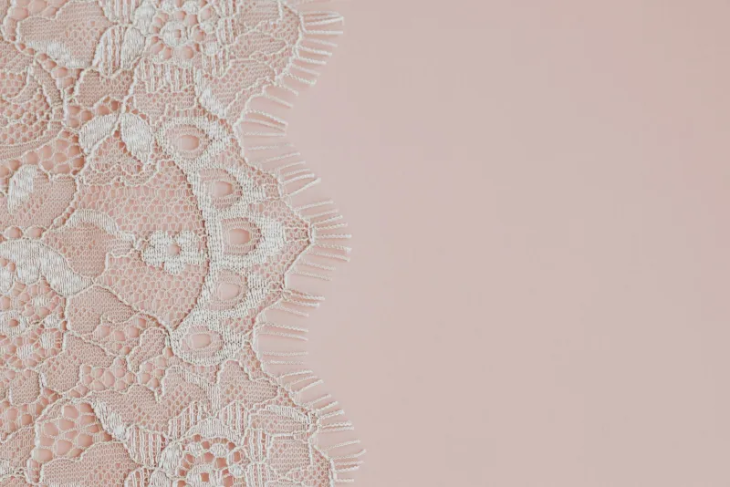 EnVie Lingerie: fuller-bust bras and swimwear from a Yorkshire specialist Delicate white lace fabric on a soft pink background