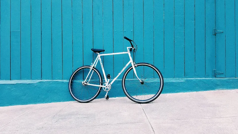 Eversure: specialist cycle, camera, car hire excess and breakdown cover White bicycle leaning against a teal wooden wall