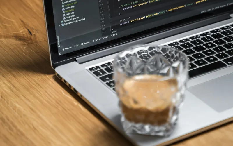 FastestVPN: lifetime VPN plans and what you get for a one-off payment A laptop on a wooden table with a glass of iced coffee in front of it