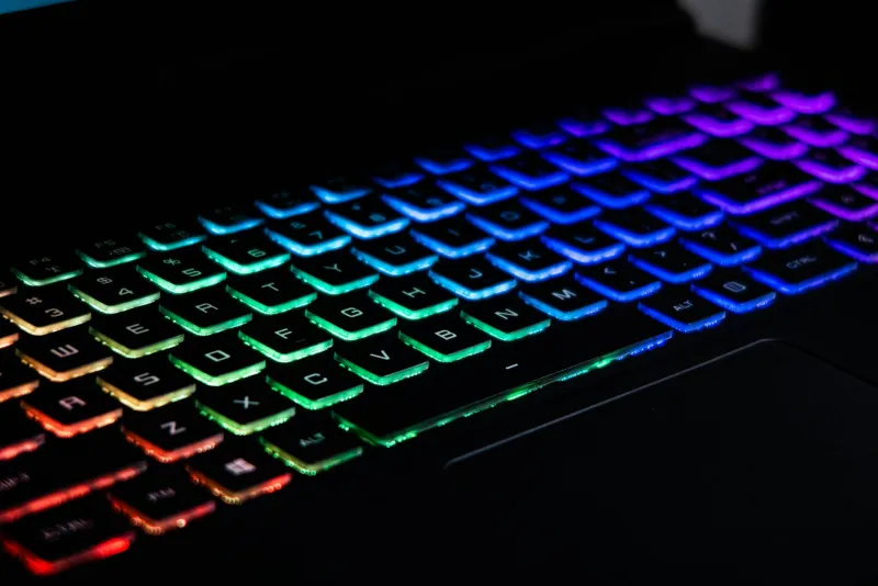 Close-up of a gaming laptop keyboard with rainbow backlighting
