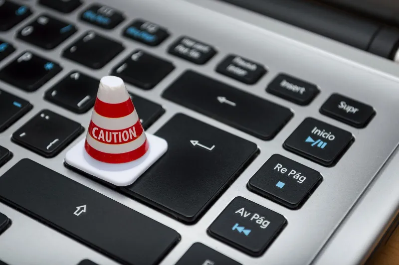 GRC Solutions: ISO 27001 and GDPR training, toolkits and books A small red and white caution cone sitting on a laptop keyboard